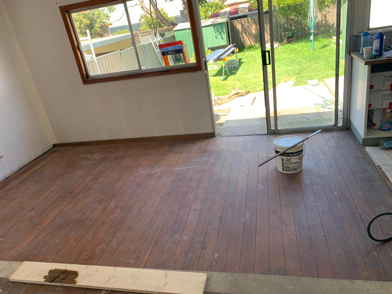 Living room timber floor with stain being applied, St Peters